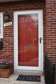 Red Paneled Door With A Storm Door Front Door Styles Door Color Red Front Door