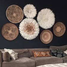 The neutral colours are perfect for the ethnic look and balance the atmosphere, especially using black and white together. Juju Hats And Baskets African Home Decor African Inspired Decor Baskets On Wall
