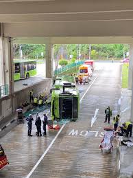 A person is seen lying on the ground outside the bus as well. Xaxifmkihdx57m