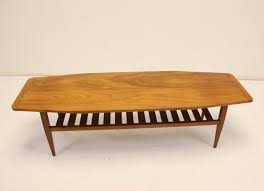 This charming side table with a rack of newspapers and magazines is a perfect piece of furniture for the waiting room or living room. Teak Coffee Table With Magazine Rack 134984
