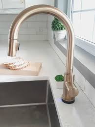 a gold kitchen faucet by delta
