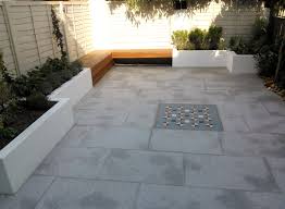 The design fits perfectly with any modern garden space and gives a polished patio look. Modern Garden Design London Granite Paving Raised Rendered Beds Hardwood Bench Mosaic Tile London London Garden Design