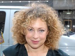 Alex Kingston looks radiant in olive green ruffled wedding dress for  italian wedding