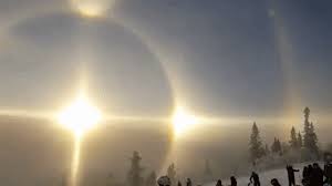 Solar/sun halos are actually a relatively common scientific and meteorological weather phenomenon caused by the presence of ice crystals floating in cirrus or cirrostratus clouds located high in the upper troposphere. A Rare And Stunning Sun Halo Appears Over A Mountain At A Ski Resort In Vemdalen Sweden