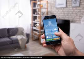 At home requires a $45 application fee. Man Using Smart Home Application On Mobile Phone Royalty Free Photo 26067780 Panthermedia Stock Agency
