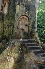 The best fairy gardens have a level of precision from the tiny napkins next to the plates on the table, to the 'smoke' coming out from the chimney. Door Of The Fairy Tree Fairy Tree Houses Fairy Tree Fairy Doors On Trees