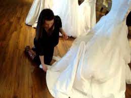 A romantic sleeveless lace wedding dress with an open back and a train. How To Pin Up A Bridal Train Youtube