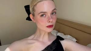 Topless Elle Fanning Sits by the Pool & Soaks up the Sun in Steamy Photos