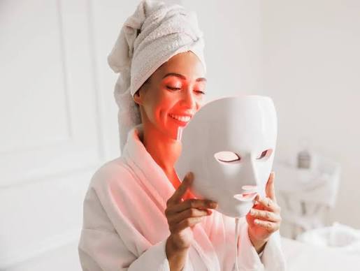 person using a red light therapy panel during a wellness session