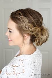 This simple pulled back hairstyle looks extra pretty with 4 stranded braids being twisted together and topped off with cute little flowers. Four Strand Braid Low Bun Missy Sue