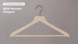 A curved piece of wire, wood, or plastic on which clothes are hung while they are being stored…. The Container Store Exclusive Wooden Hangers Youtube