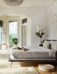 A colorful bedroom with super bright bedding and pillows, a colorful planter with painting and bright artworks on the wall. Eight Stunning Bedrooms To Inspire You Cb2 Style Files