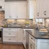 The kitchen island features the same glossy granite as the surrounding countertops, adding a feeling of visual consistency to the space. 3