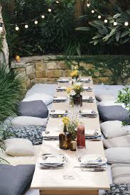 The Long Picnic Table Setting With Floor Cushions Rugs And Festoon Lighting Just Crying Out To G Garden Furniture Plans Garden Landscaping Diy Outdoor Dinner