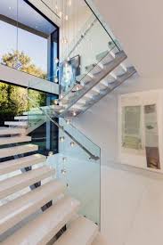 Cool contemporary wood 3/4 turn staircase with chrome and glass railing. Modern Staircase Designs For Homes