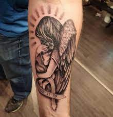 Wonderful Grey Ink Mother Angel Holding Baby With Date Banner Tattoo On Forearm Beautiful Angel Tattoos Angel Tattoo For Women Angel Tattoo Designs