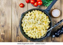 Everybody loves macaroni and cheese: Mac And Cheese American Style Macaroni Baked Pasta With Cheesy Sauce In Pan Wooden Background Copy Space Top View Poster Id 285073357