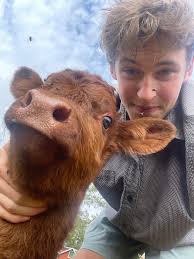 So we acquired some two year old unbred Highland heifers in June and  Suprise! Angus made his appearance yesterday. Here he is posing with his  new friend Jack! Angus is frisky and