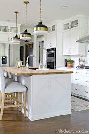 The slotted shelves and spindle legs of this kitchen island are reminiscent of french quarter architecture. Build Out A Kitchen Island With Side Panels Thrifty Decor Chick Thrifty Diy Decor And Organizing