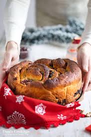 Ground cinnamon and cinnamon sticks arranged around Christmas cookies”