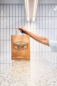 In This Modern Butcher White Rectangular Tiles With Dark Grout Cover The Walls And The Service Counter Is Made Butcher Shop Butcher Store Butcher Restaurant