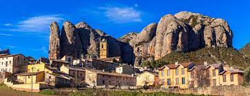 View at the aguero village with mallos de aguero rock formations in spain. Aguero In The Shadow Of The Spectacular Formation Of Mallos De Aguero Fascinating Spain
