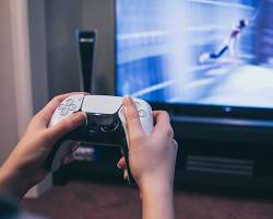 Image of person holding a Playstation 5 controller