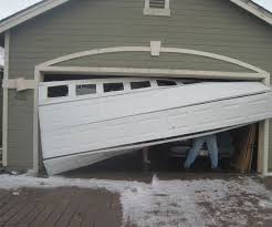 Eye Opening Reasons For Bent Misaligned Damaged Garage Door Track Broken Garage Door Garage Door Installation Garage Door Panels