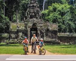 Image of group of tourists exploring Angkor Wat by bicycle