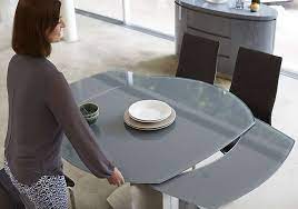 A sturdy and stylish dining table with a bold and elegant design. Flow Swivel Glass Extending Dining Table With 4 Chairs Extendable Dining Table Tempered Glass Table Top Dining Table