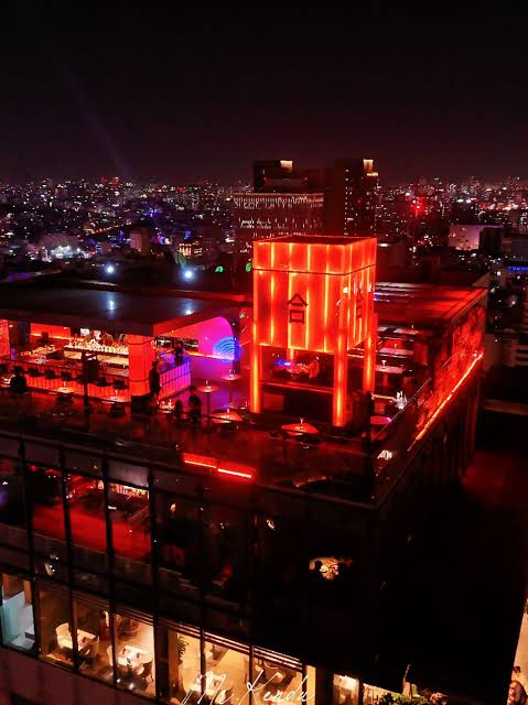 A neon-lit rooftop bar with a Hong Kong vintage aesthetic