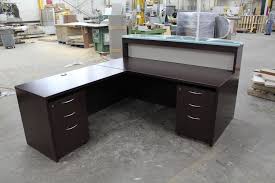 Each piece is finished in a warm, burnt sienna and features pewter finished hardware. Dark Wood Mahogany Reception Desk With A Glass Transaction Or Sales Counter This L Shaped Front De Reception Desk Mahogany Reception Desk Reception Desk Diy