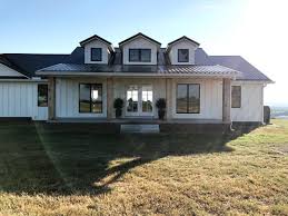 Black And White House Exterior One Story White Board And Batten Siding With Black Roof Farmhouse White Farmhouse Exterior House Exterior Modern Farmhouse Exterior