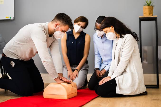 Instructor teaching diverse students CPR