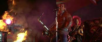 I always had a huge crush on the sweaty saxophone player in the lost boys movie, who doesn't love a big sweaty oiled up long haired guy in spandex pants, a bulging codpiece, covered in chains and gyrating and grinding his hips as he plays the sax. Cool Horror Gear The Lost Boys Sax Player Xmas Sweater