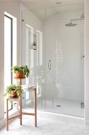 Mosaic tile in the shower flooring and shelf area accents this clean design and the running bond grid flooring pattern directs your eye toward this. Selecting The Best Tiles Can Create The Distinction Between Common And Superb B Between Modern White Bathroom Bathroom Tile Designs Bathroom Remodel Master