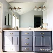 The wispy gray hue complements the varied tones at play in the pearly calacatta wainscoting and polished nickel hardware featured throughout the design. How To Paint A Bathroom Vanity Diy Inspired