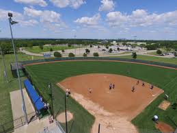A softball on a field. Dallas College Mountain View Campus On Twitter How Cool Is This Drone Shot Of Our Softball Field Drones Mvcsoftball Downtowndallas Is In The Background