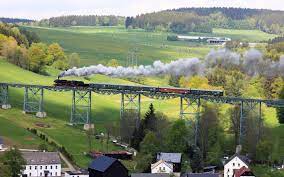 The ore mountains (erzgebirge) are a low mountain range in the east of germany. Wallpaper Erzgebirge Saxony Germany Bridge Train Pasture Houses 2880x1800 Hd Picture Image