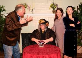 A spiritualist medium holds a seance for a writer suffering from writers block but accidentally summons the spirit of his deceased first wife which leads to an increasingly complex love triangle with his current wife of five years. Noel Coward For What S Ailing You Boothbay Register