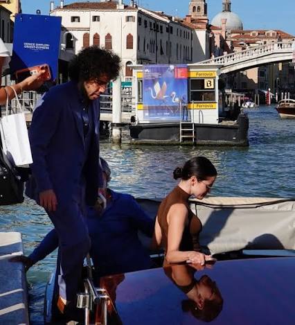 Selena Gomez and Benny Blanco share a kiss in a water taxi after arriving  in Venice. The couple held hands while making their way through the city.  See all the photos at