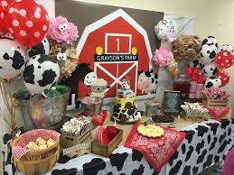 The big red barn cake and happy sunshine cupcakes are only two of the many treats on the table. First Birthday Farm Theme Novocom Top