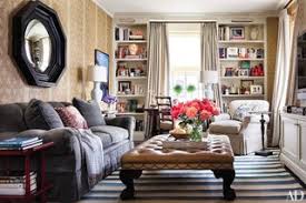 Use an adorable coffee table to display decor pieces and family photos. How To Incorporate Ottomans Into Your Living Room Decor Architectural Digest
