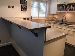 Quartz Worktops With Raised Breakfast Bar And Chrome Leg Supports Quartz Countertops Countertops House Design