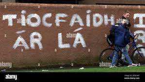 Young Boys Pass A Wall Bearing The Irish Republican Army Ira Graffitti In Irish Meaning Our Day Will Come In Poleglass West Belfast February 26 Chief Of Defence Staff Sir Charles Guthrie