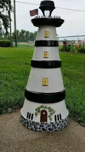 Solar Light Topped Light House From Terra Cotta Pots Terra Cotta Pot Crafts Clay Pot Lighthouse Solar Light Crafts