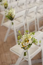 Spring Floral Arrangements On White Resin Folding Chairs Yyceventrentals Www Greateventsrent Wedding Ceremony Chairs Ceremony Flowers Rustic Wedding Ceremony