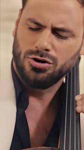 Hauser playing cello with guitar