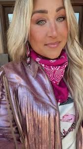 @roughie.mcduffie feelin' fancy with our new #VelvetRodeo fragrance ✨  #mirandalambert #idyllwind #bootbarn #perfume #fringe #parfum #pink #cowgirl