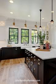 Black And White Farmhouse Kitchen Black White And Antique Brass Are A Classic Finish Combination In This Modern Farmhouse Kitchen Blacka Modern Farmhouse Kitchens Kitchen Style Home Kitchens